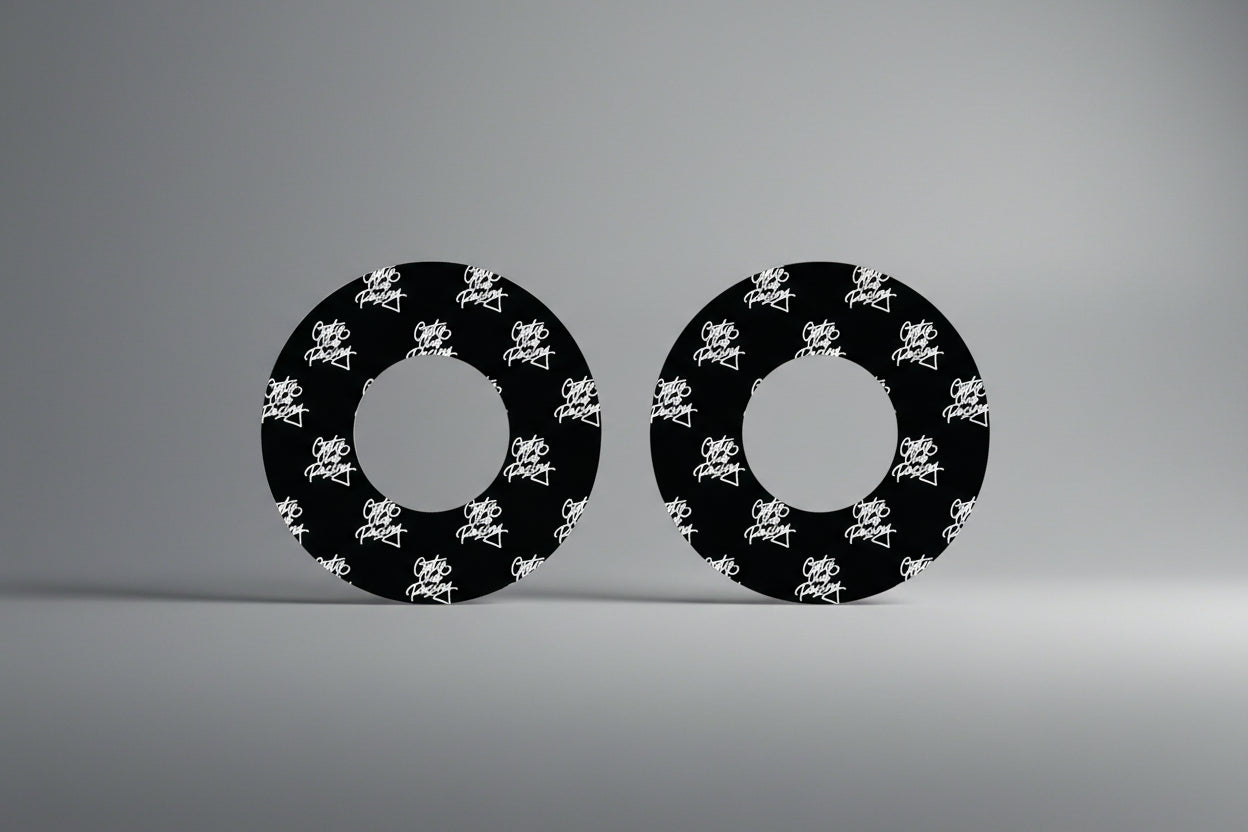 Two black circular objects with white text on a gray background