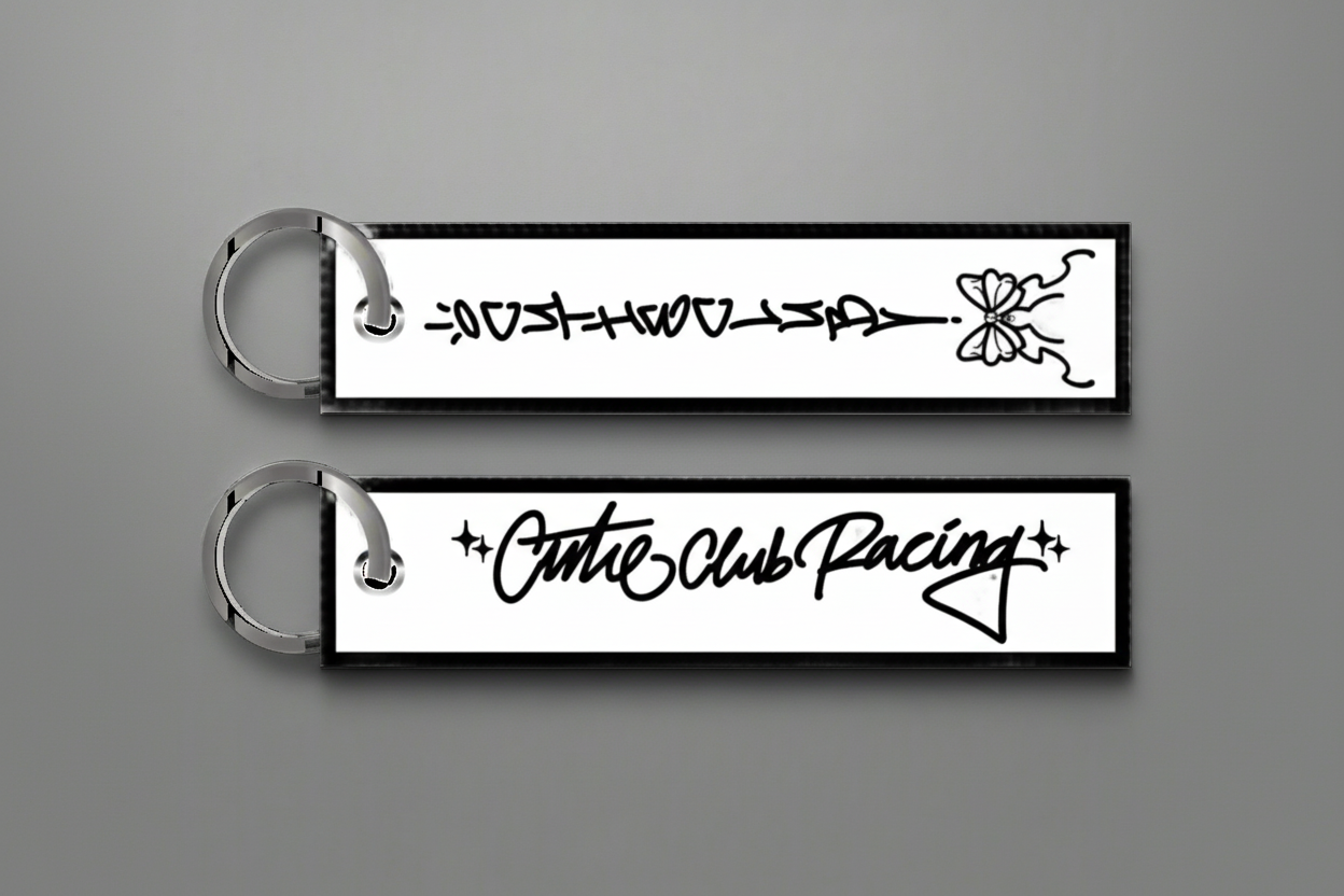 Two keychains with decorative text and designs on a white background