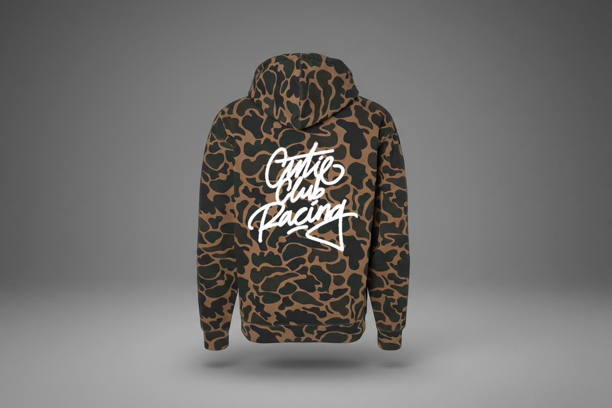 Camouflage hoodie with 'Couture Club Racing' text on the back against a white background